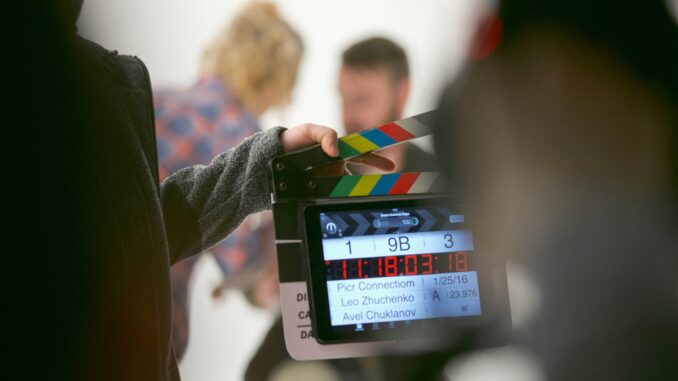 person holding clapperboard